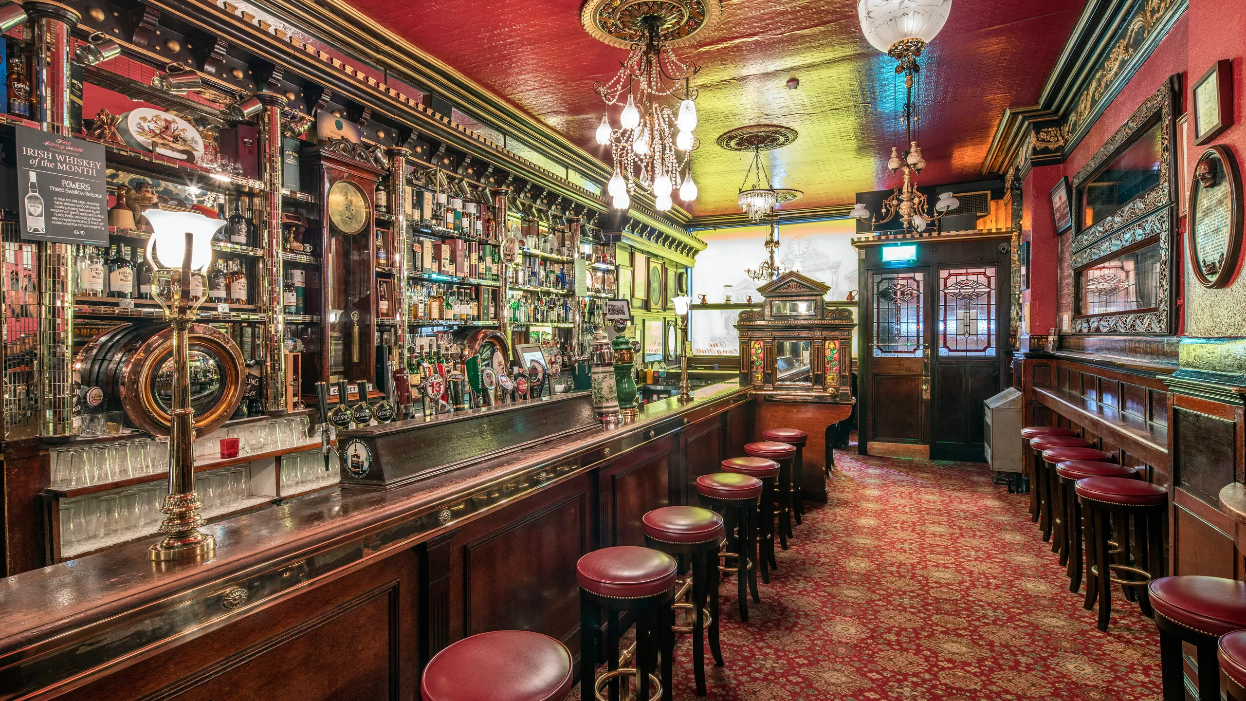 The Long Hall pub in Dublin — Victorian interior with dark wood, brass fixtures, and warm atmosphere