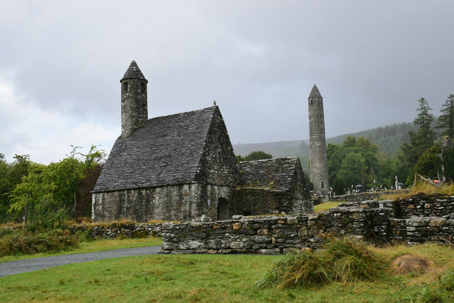 Glendalough round tower rising above the glacial valley in the Wicklow Mountains — ancient monastic site surrounded by mist